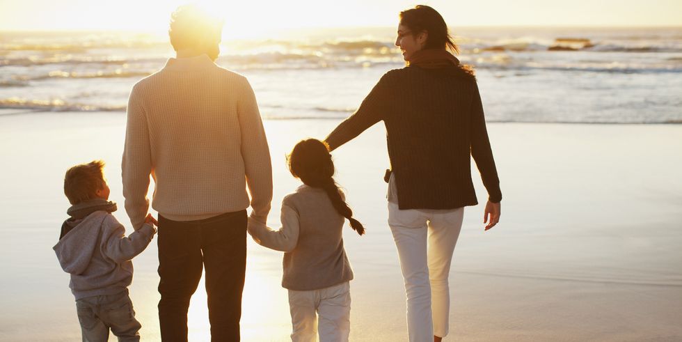A family walking together on a New Zealand beach
